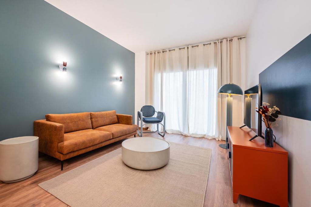 a living room with a couch and a table at Sweett - Carrer Bailen in Barcelona