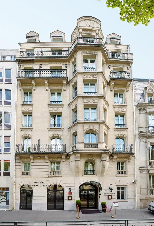 an apartment building in front of a street at Grand Hôtel Champs-Elysées in Paris