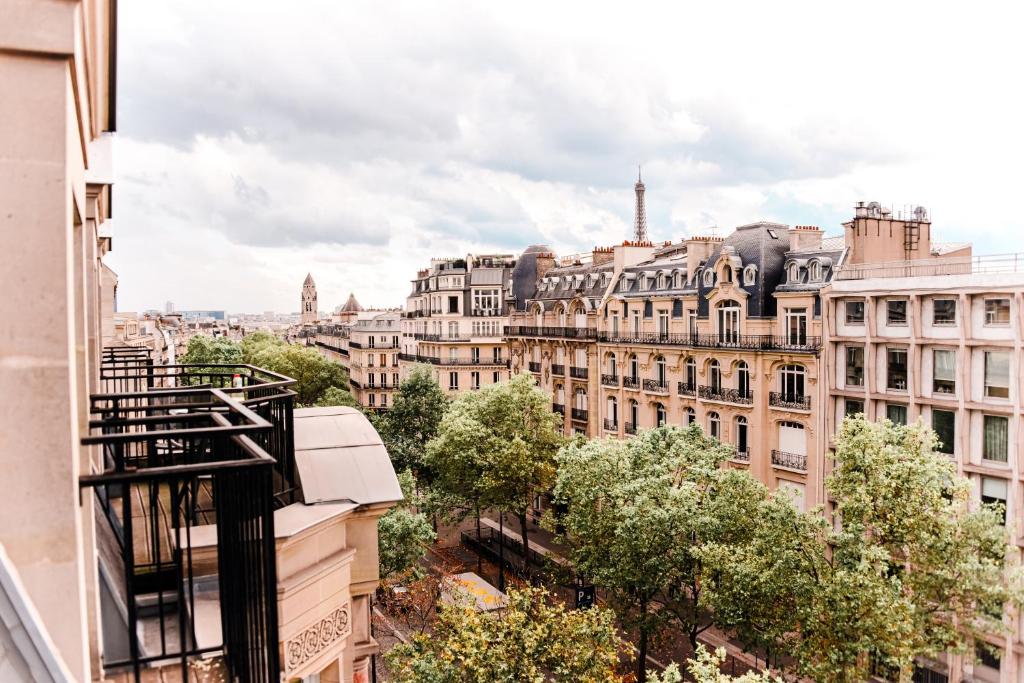 a view of the city from the balcony of a building at Grand Hôtel Champs-Elysées in Paris