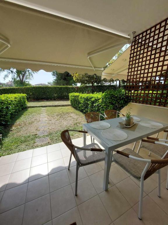 a white table and chairs on a patio at Villa Danai Nefeli Siviri in Siviri