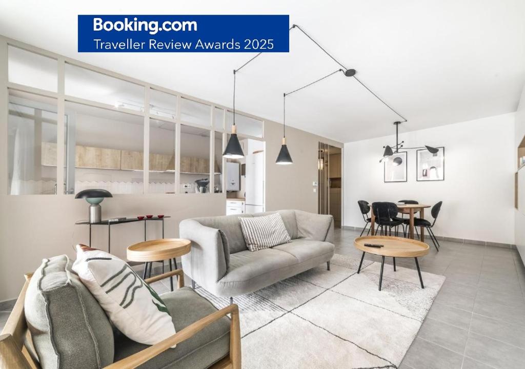 a living room with a couch and a table at Élégant T3 au Panier Vieux Port avec Terrasse Privée et Parking in Marseille