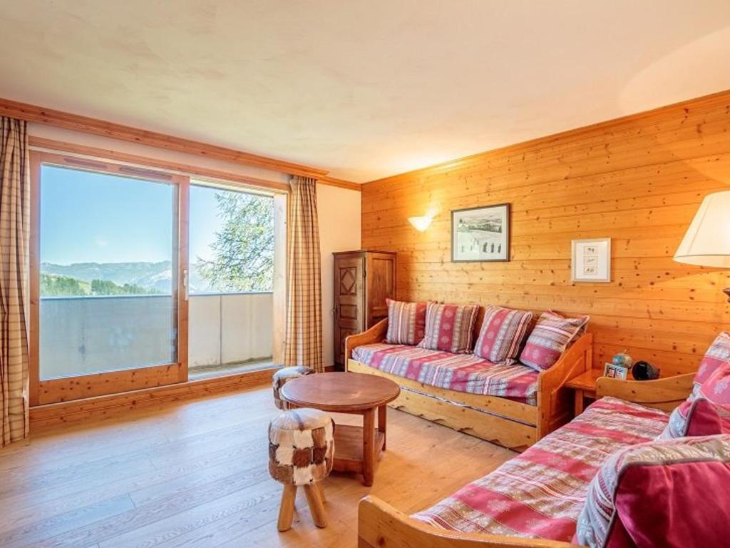 un salon avec un canapé et une table dans l'établissement Appartement cosy 3 pièces, piscine, sauna, hammam, à 100m des pistes, parking couvert inclus - FR-1-351-28, à La Plagne