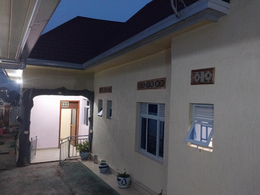 a house with a blue roof and a door at MARACANA Taverna Ltd in Kigali