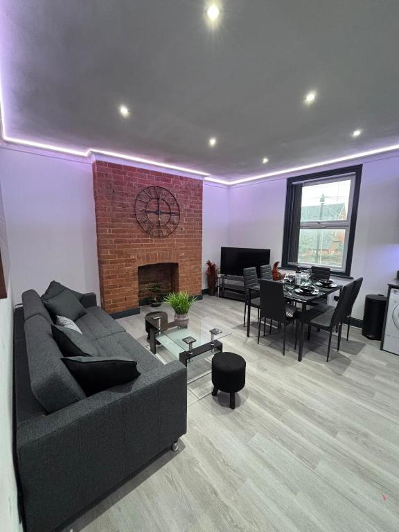 a living room with a couch and a dining room at Luxury Living in Reading Town Centre in Reading