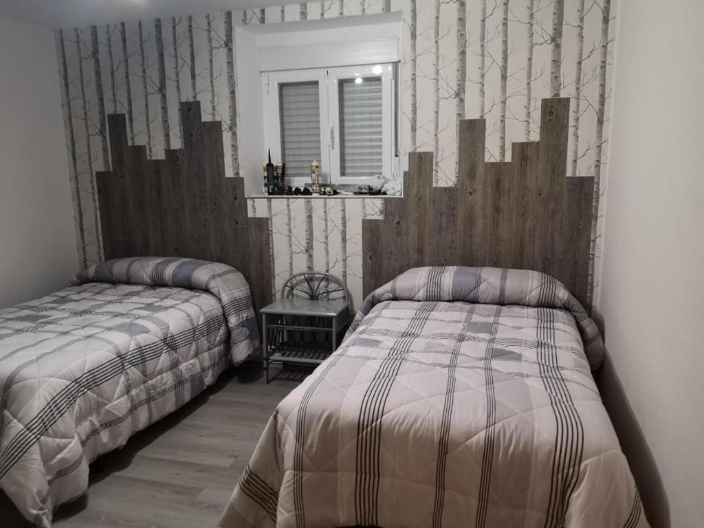 Postel nebo postele na pokoji v ubytování Los Tres Hórreos