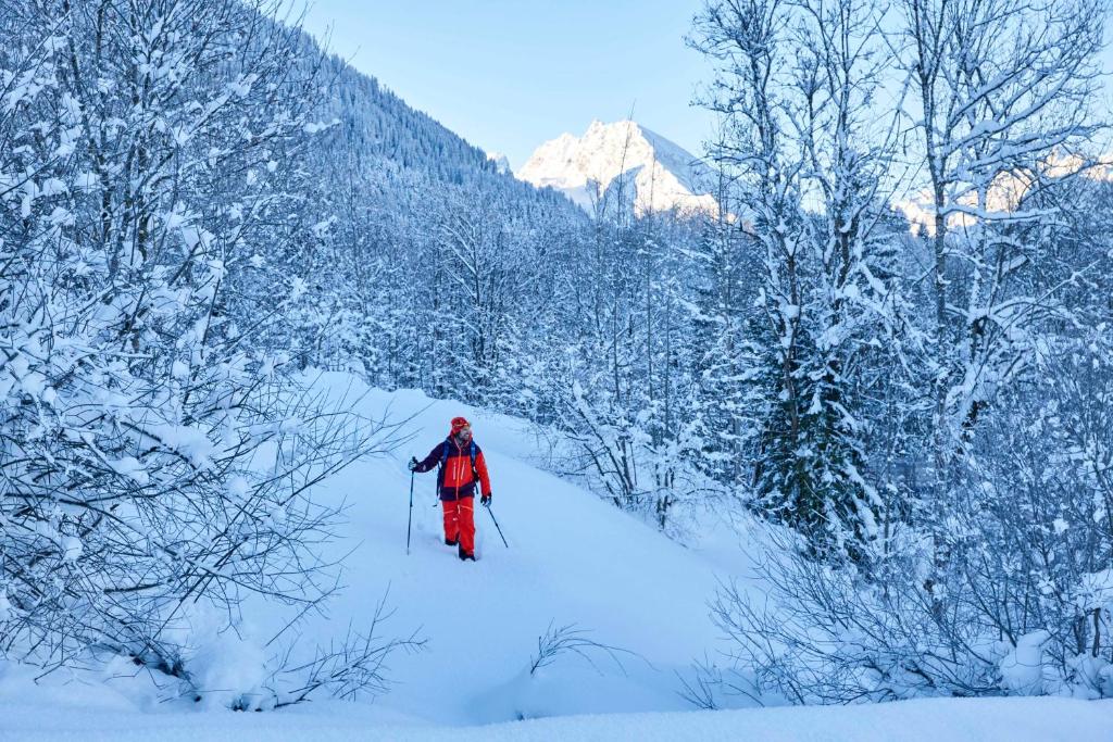 a person is cross country skiing in the snow at Kempinski Hotel Berchtesgaden in Berchtesgaden