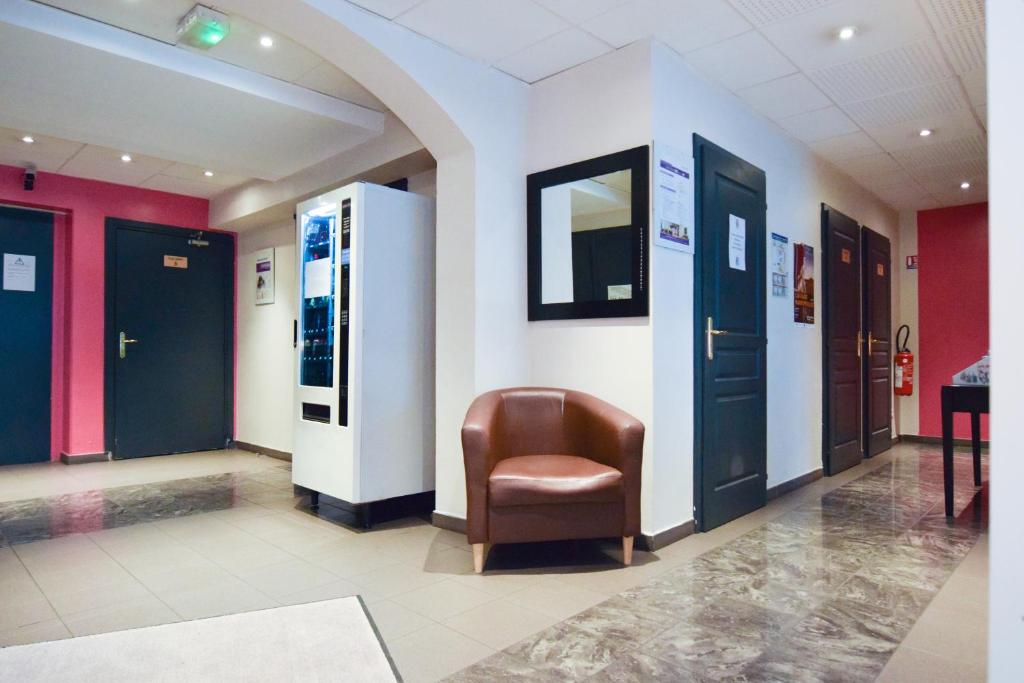 a waiting room with a chair in a building at Residhotel Mulhouse Centre in Mulhouse