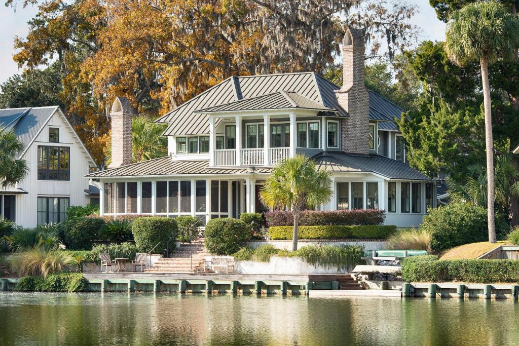 a house with a pond in front of it at 4 Bedroom Wilson Village Home 31 in Bluffton