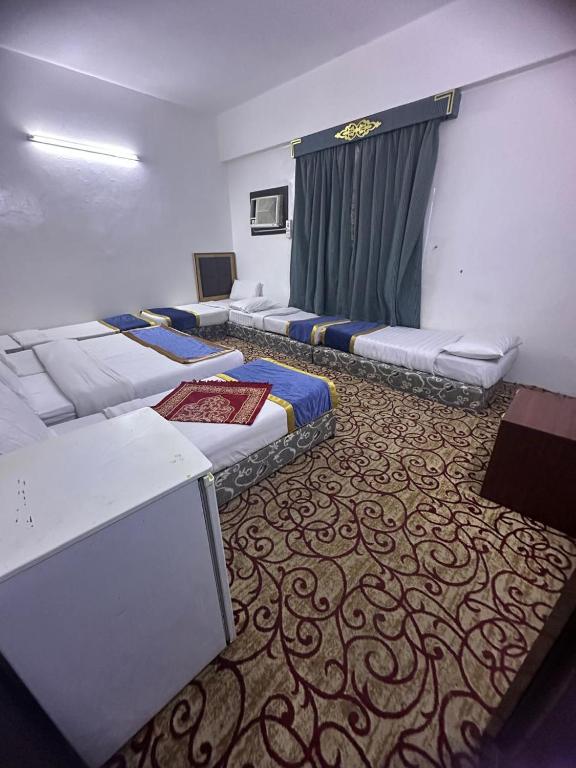 Ένα ή περισσότερα κρεβάτια σε δωμάτιο στο عمارة روتانا