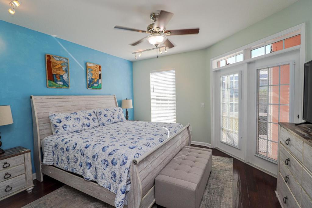 een slaapkamer met een bed en een plafondventilator bij Seaside at Anastasia B105 in St. Augustine