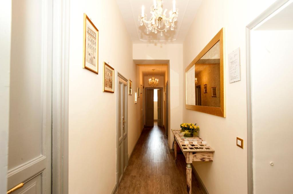 a hallway with a table and a mirror at Sleep In Rome Ludovisi in Rome