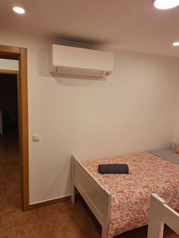 a bedroom with a bed and a air conditioner on the wall at Monteverde in Monte Negro