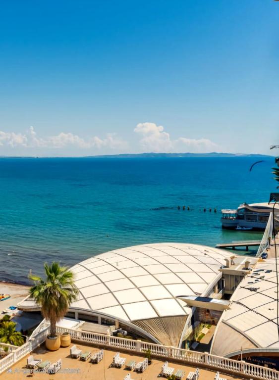 a building on the beach next to the ocean at Premium Sea View Big Apartament in Durrës