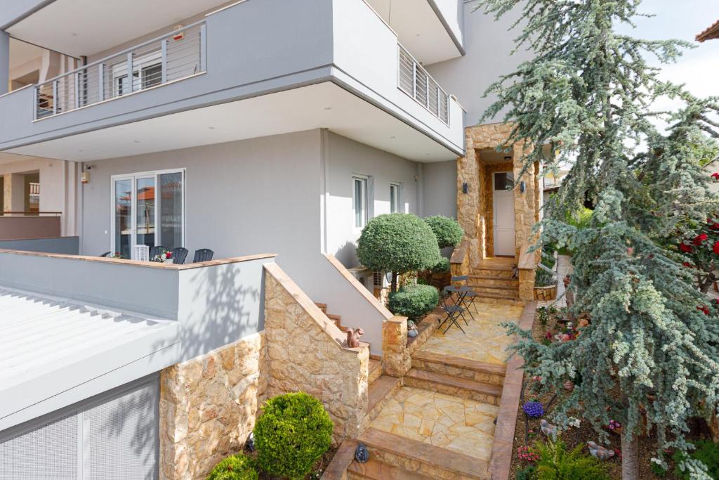 a house with a staircase in front of it at Βίλα Ιωάννα 3 in Mesimérion