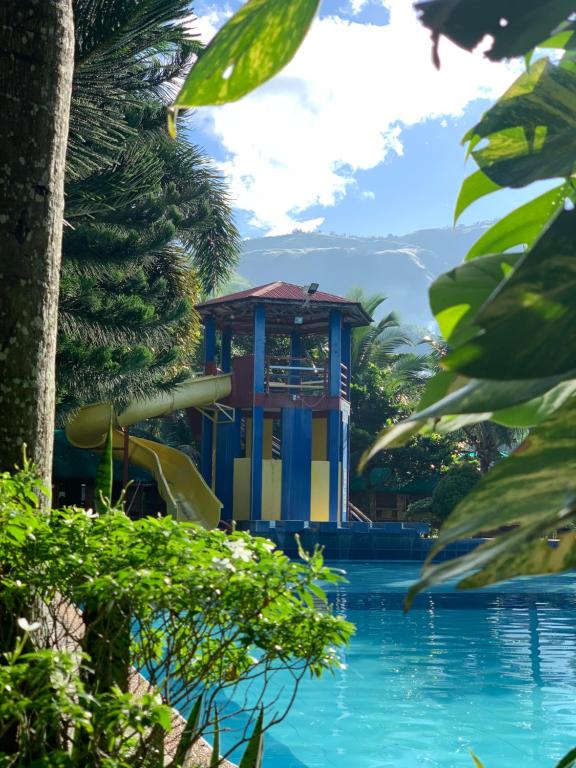 a pool at a resort with a water slide at Valley Breeze Resort in Gabaldon