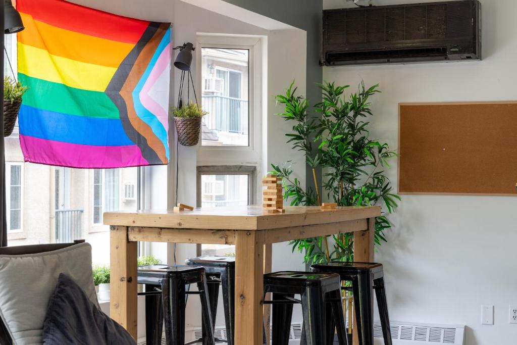 a table with a rainbow flag hanging in a room at Samesun Banff Hostel in Banff