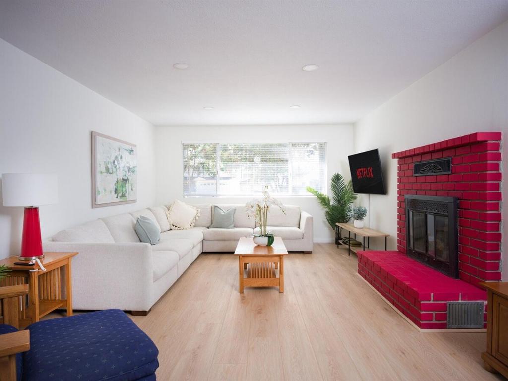 a living room with a white couch and a fireplace at Family Home, Pool, Pong, Nintendo in Simi Valley
