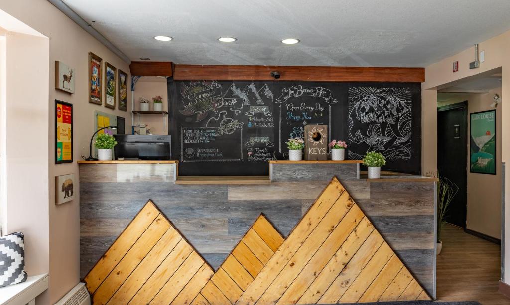 a bar in a restaurant with a chalkboard wall at Samesun Banff Hostel in Banff