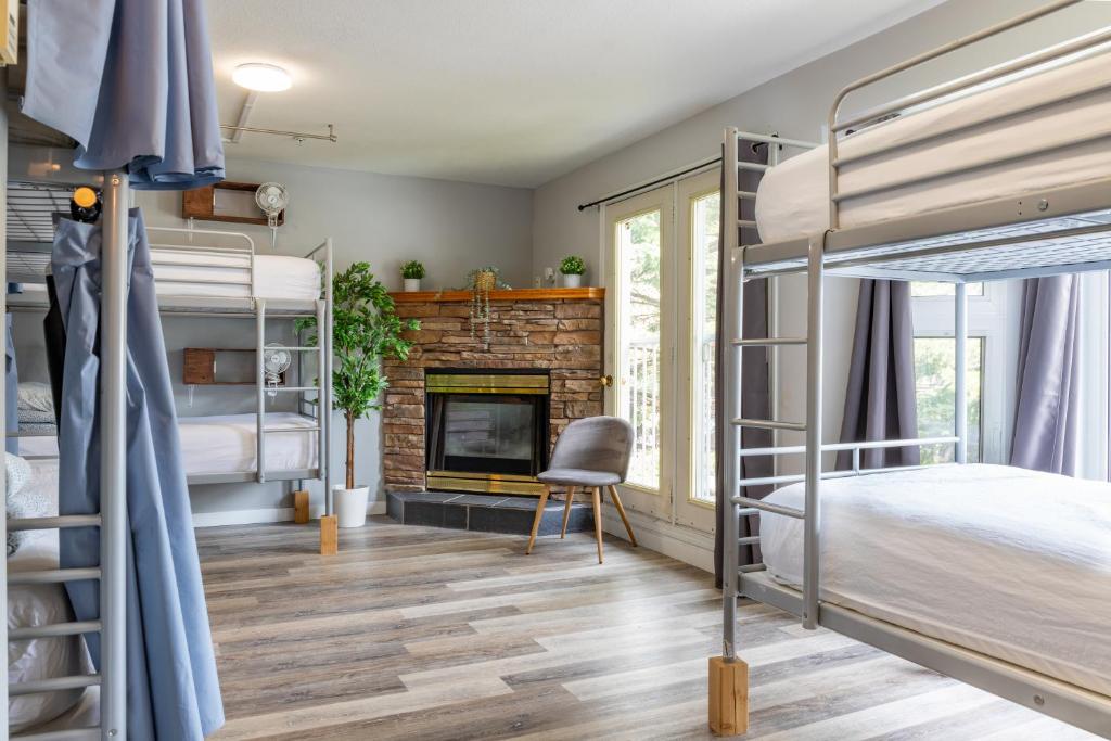 a bedroom with bunk beds and a fireplace at Samesun Banff Hostel in Banff