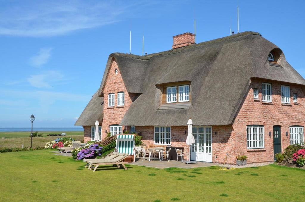 a large brick house with a thatched roof at LITZKOW 12806 in Westerwall