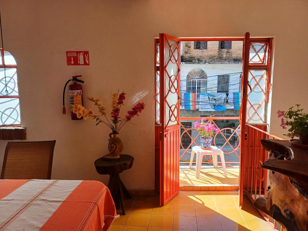 a bedroom with a door open to a patio at Hotel Ana Liz in Puerto Vallarta