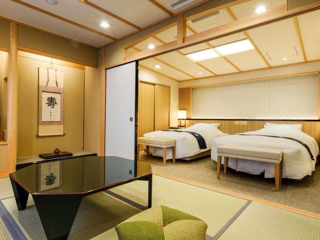 Postel nebo postele na pokoji v ubytování Arima Hot Spring Ryokan Hanamusubi