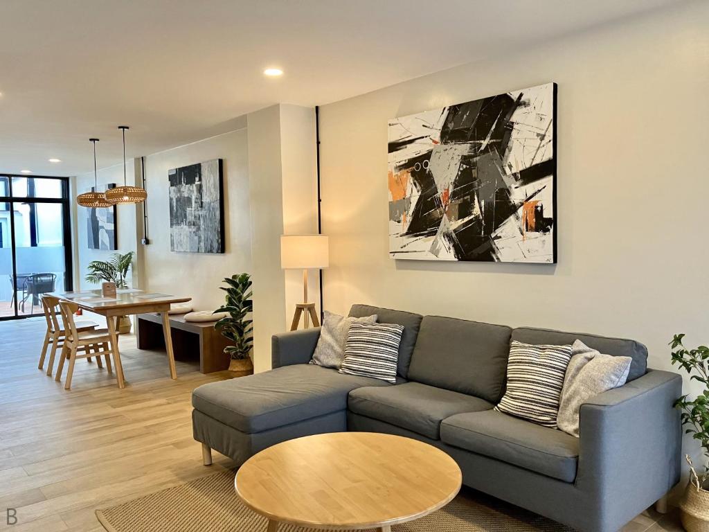 a living room with a couch and a table at Private Cozy Townhouse Near Lanmuang Village in Ban Pa Kluai