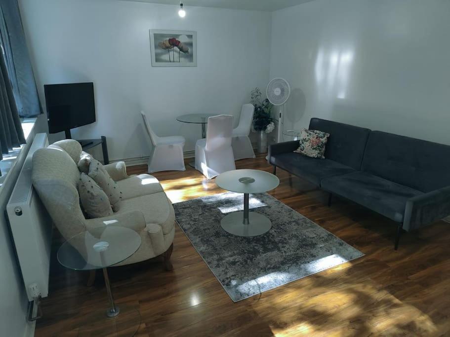 a living room with a couch and a table at Urban Oasis with Private Terrace in London