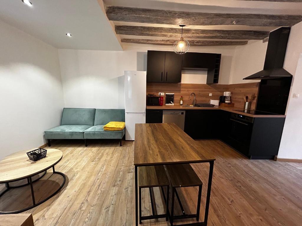 une cuisine et un salon avec un canapé et une table dans l'établissement Maison de charme T3 rénovée avec jardin à Vicq-sur-Gartempe, proche La Roche-Posay - FR-1-541-165, à Vicq-sur-Gartempe