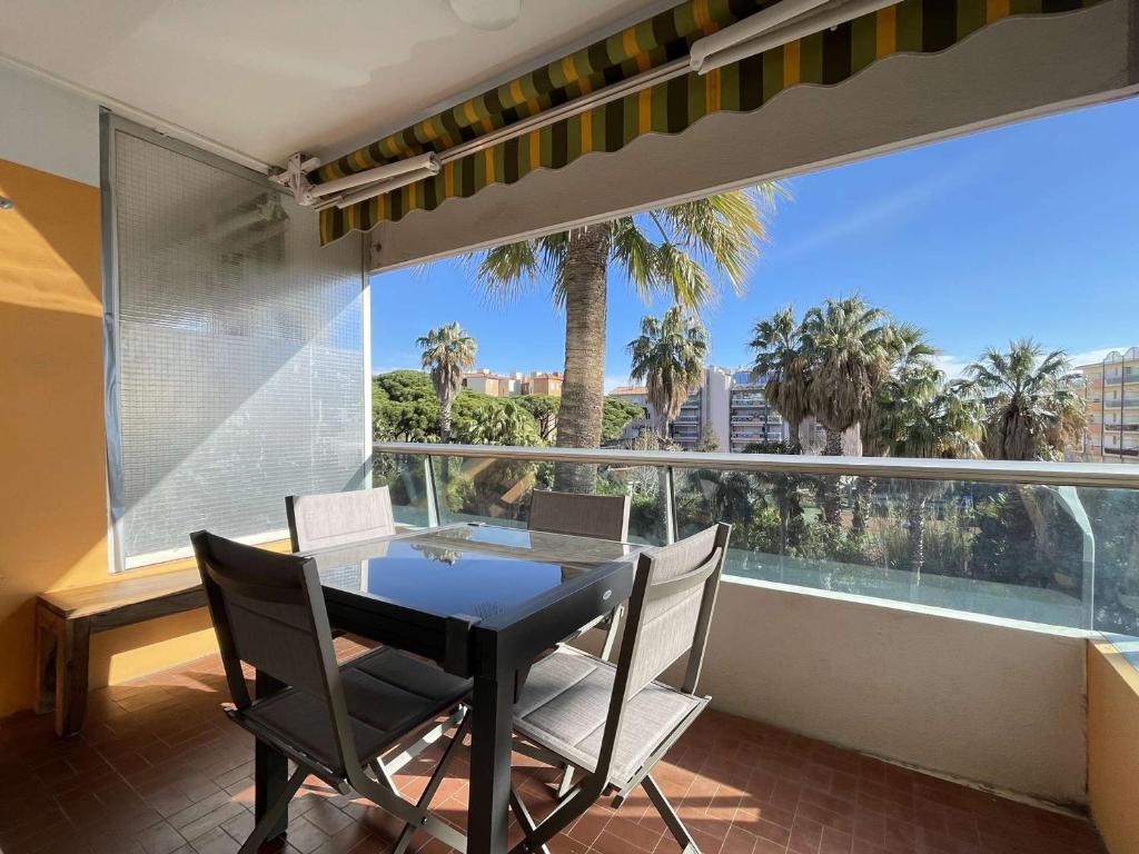 une salle à manger avec une table et des chaises et une grande fenêtre dans l'établissement Appartement T2 Lumineux avec Parking Privatif - Centre-Ville - FR-1-308-203, au Lavandou