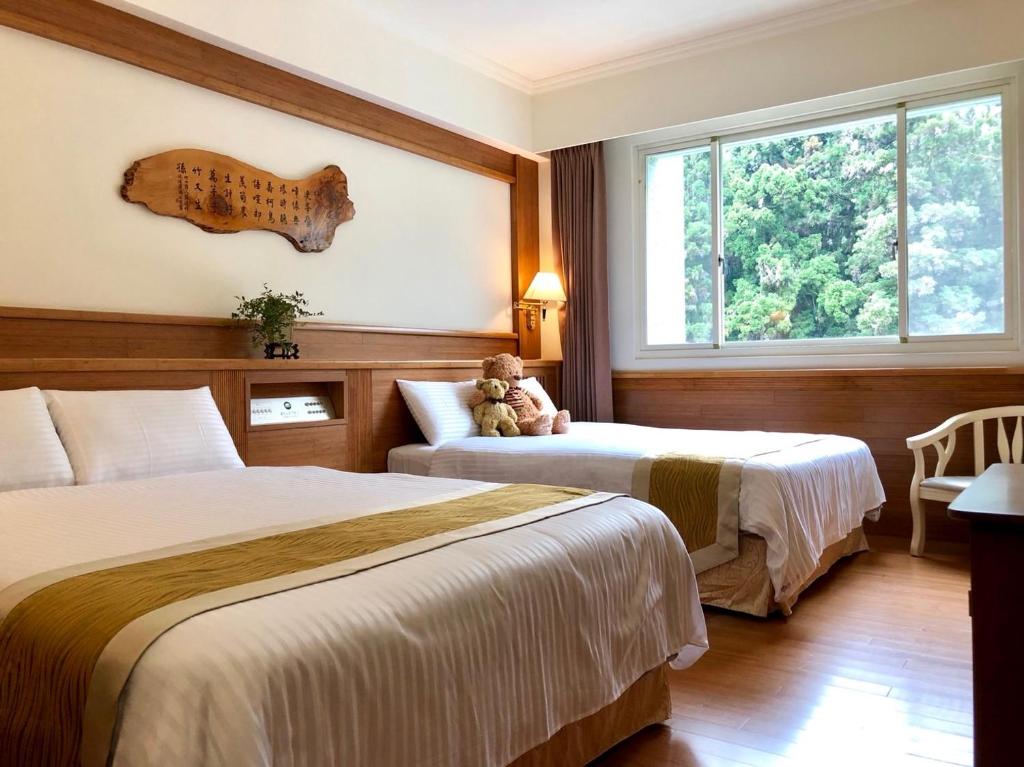 Postel nebo postele na pokoji v ubytování Ginkgo Hotel