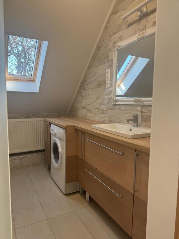 łazienka z umywalką i pralką w obiekcie Borsi Apartman w mieście Balatonalmádi
