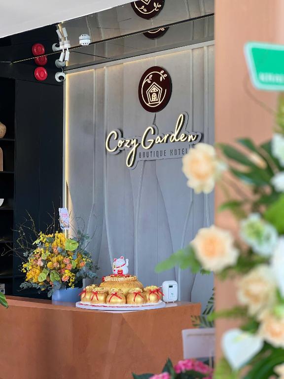 a sign for a city bakery with a cake on a table at Cozy Garden Boutique hotel in Khu Chi Lăng