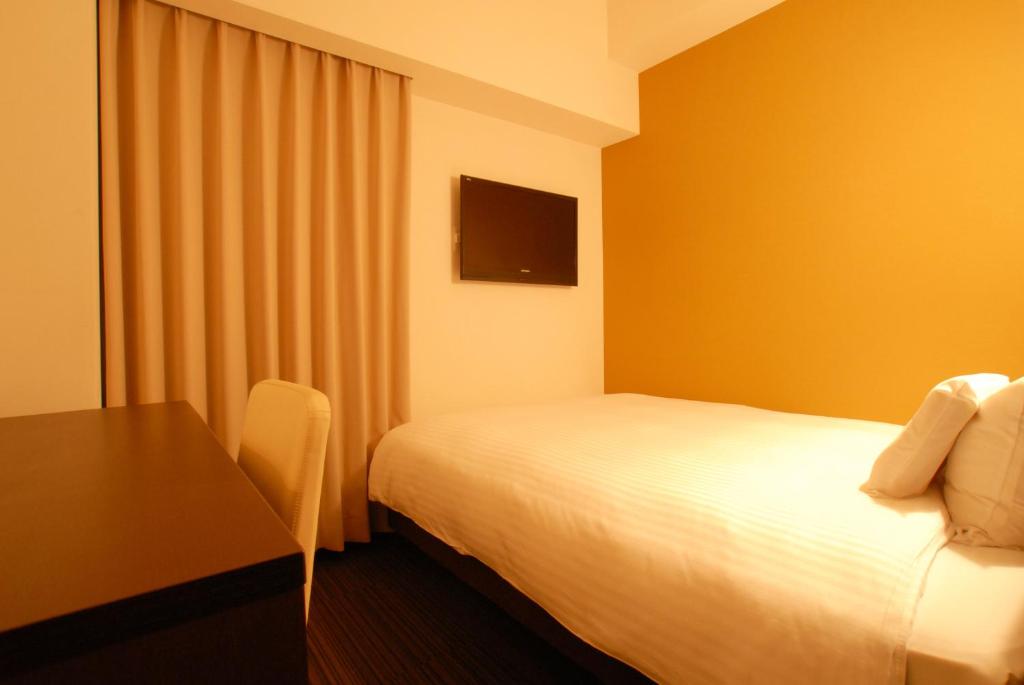 Postel nebo postele na pokoji v ubytování AB Hotel Komaki