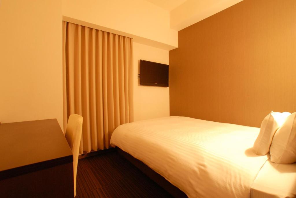 Postel nebo postele na pokoji v ubytování AB Hotel Komaki