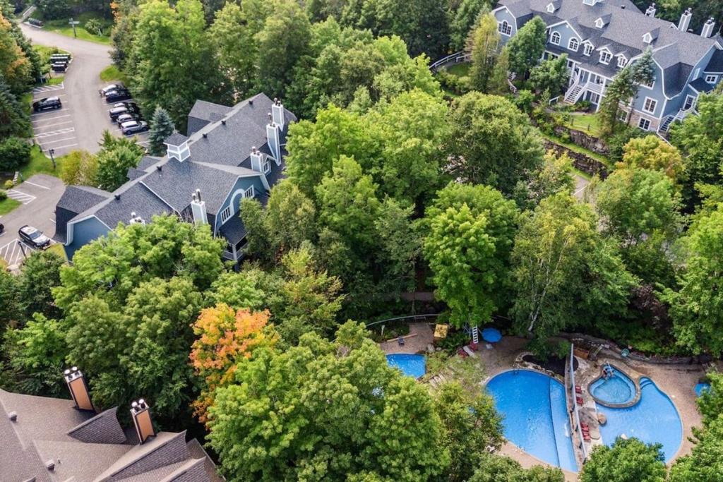 an aerial view of a house with a swimming pool at Les Manoirs 3bdrs Near Village in Mont-Tremblant