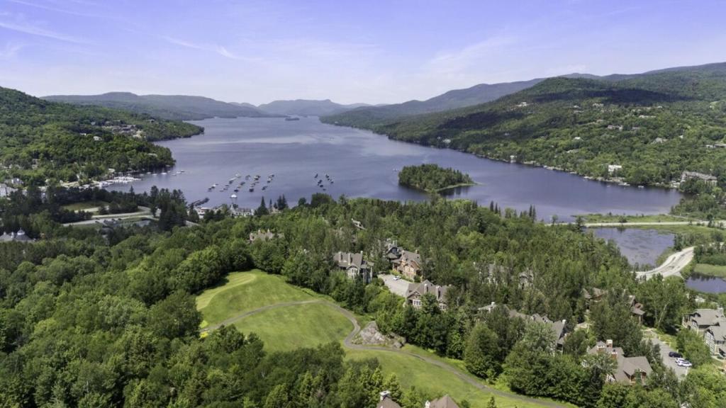 an aerial view of a lake with boats in the water at Les Manoirs 3bdrs Near Village in Mont-Tremblant