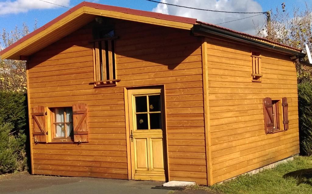 a small wooden building with a door and a window at Gîte-Duplex La K-Bane 3 impasse des jardins Piscine et Jacuzzi à 500m in Saint-Flour