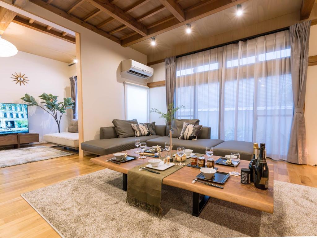 a living room with a couch and a table at お宿Gａｎ錦町 in Takamatsu