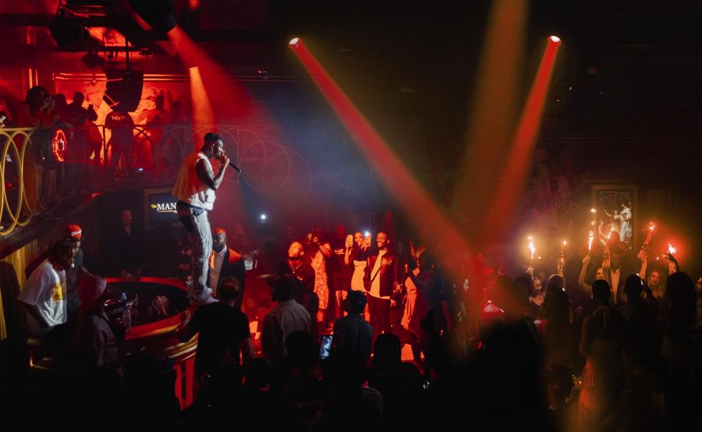 a man singing on a stage in front of a crowd at FIVE Jumeirah Village in Dubai
