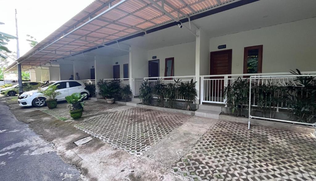 a white car parked in front of a building at Maisaba Living Sibang Gede in Bringkit
