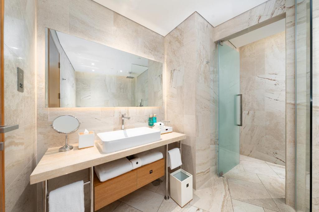 a bathroom with a sink and a mirror at FIVE Jumeirah Village in Dubai