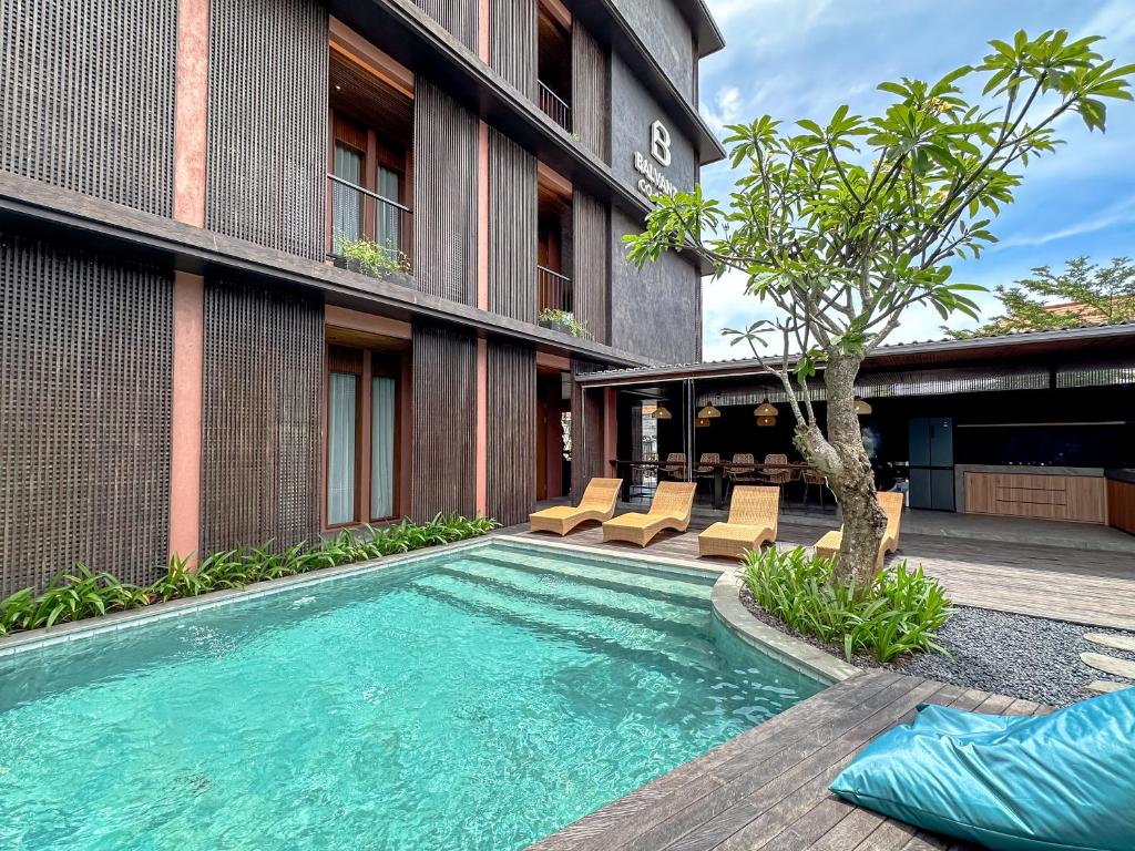 a swimming pool in front of a building at Balvanta Coliving in Kerobokan