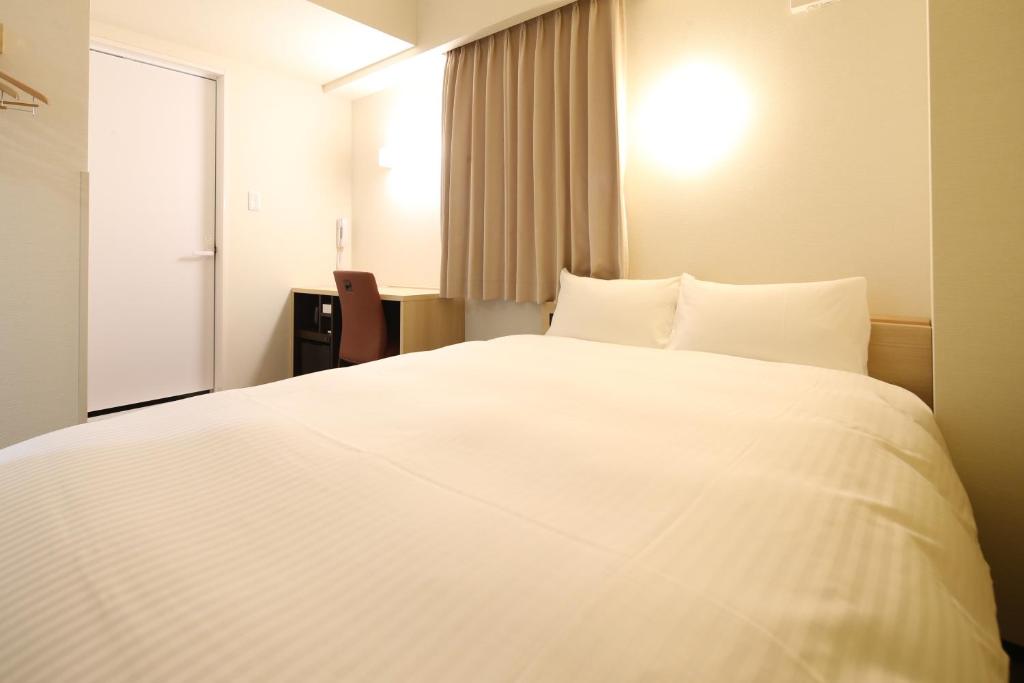 Postel nebo postele na pokoji v ubytování AB Hotel Seki