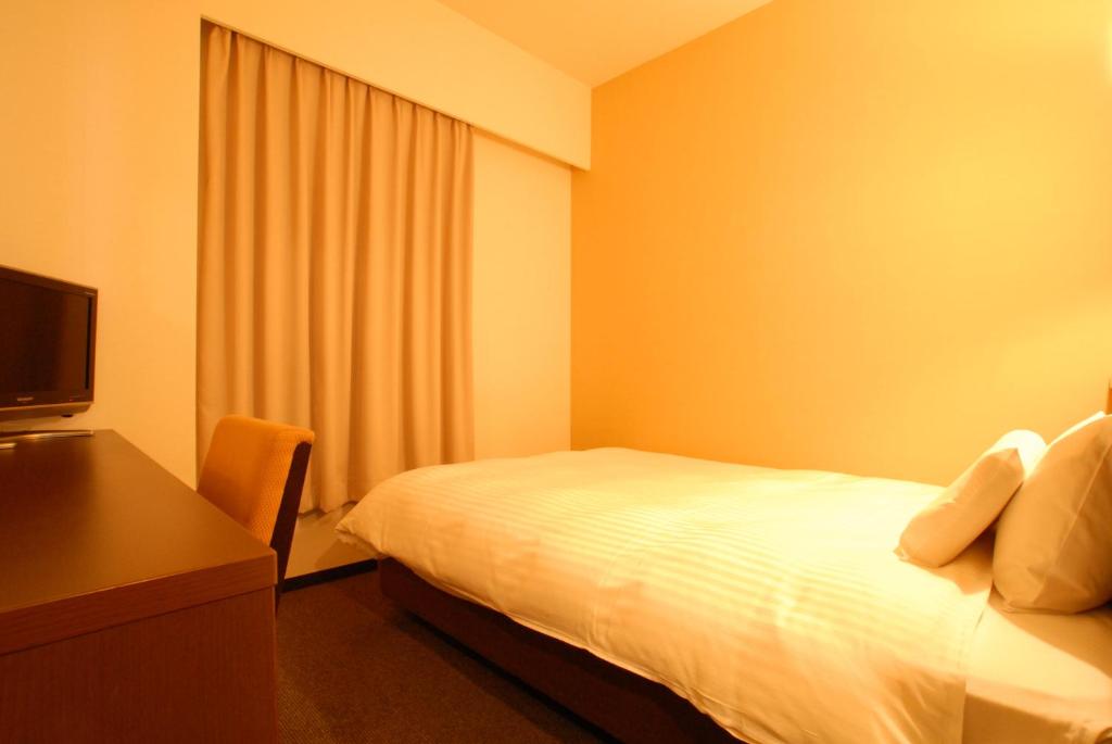 Postel nebo postele na pokoji v ubytování AB Hotel Okazaki