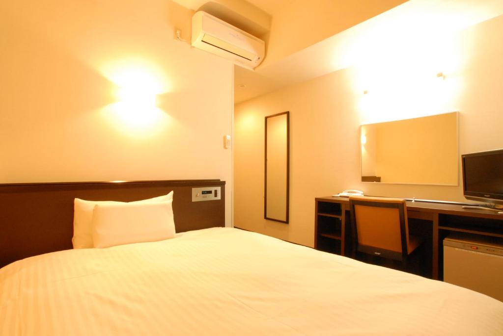 Postel nebo postele na pokoji v ubytování AB Hotel Okazaki