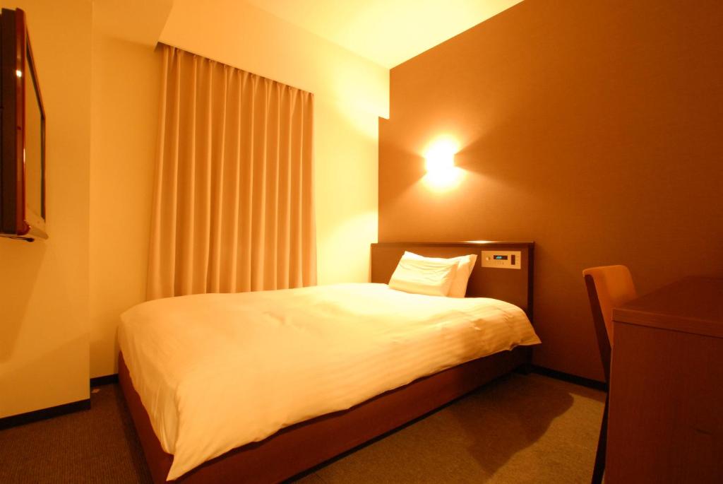 Postel nebo postele na pokoji v ubytování AB Hotel Okazaki