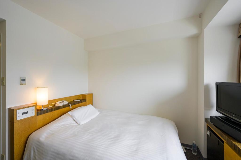Postel nebo postele na pokoji v ubytování Twin Leaves Hotel Izumo