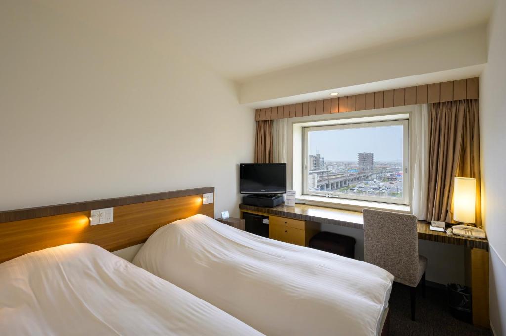 Postel nebo postele na pokoji v ubytování Twin Leaves Hotel Izumo