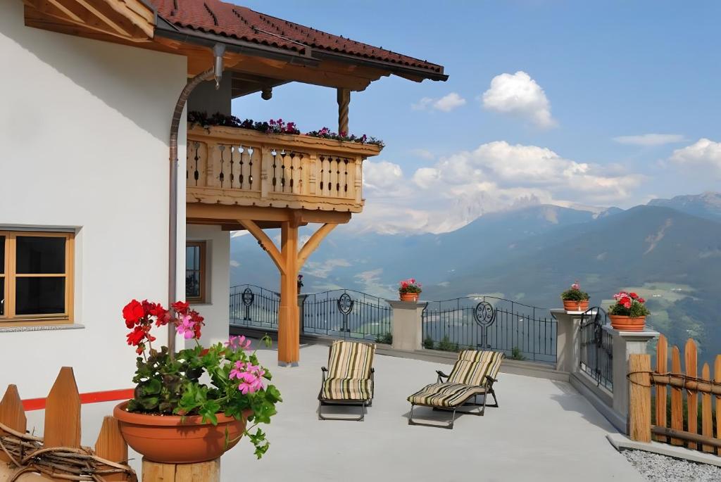 a balcony with chairs and a gazebo at Mitterhof in Villandro